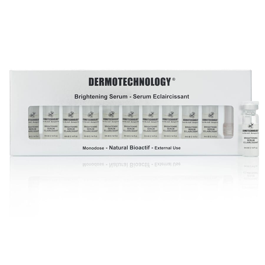 Box of DERMOTECHNOLOGY® Brightening Serum monodose vials for external use, aimed at reducing dark spots and enhancing skin luminosity.