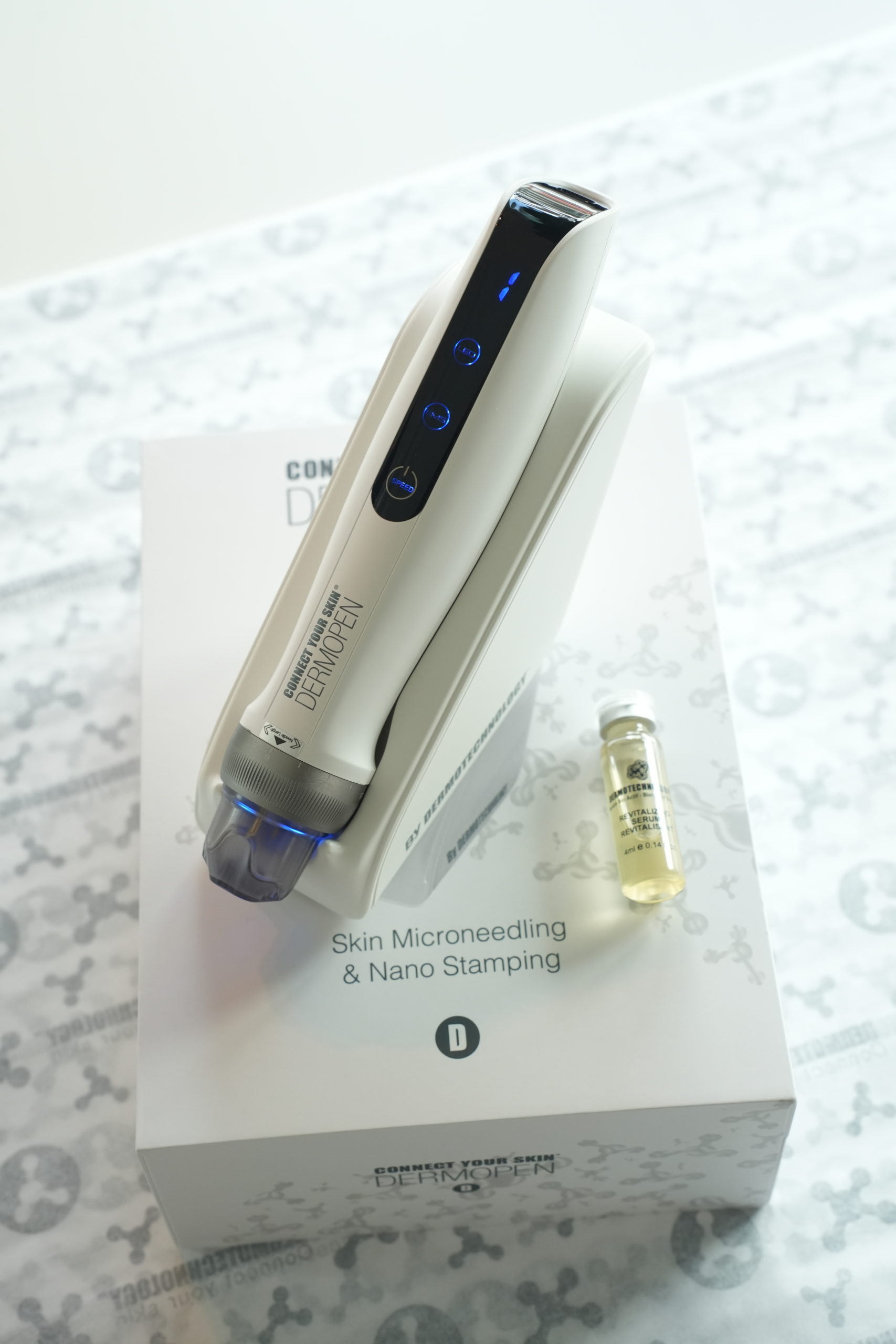 Dermopen professional microneedling device displayed on packaging